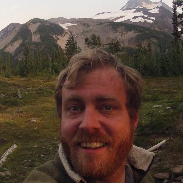 KC Walsh in front of a mountain