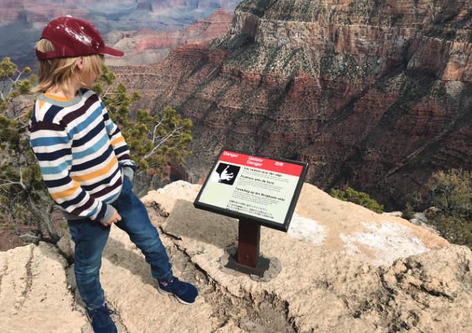 Child looking at a sign in a national park