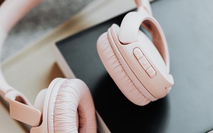 Picture of pink headphones on a desk